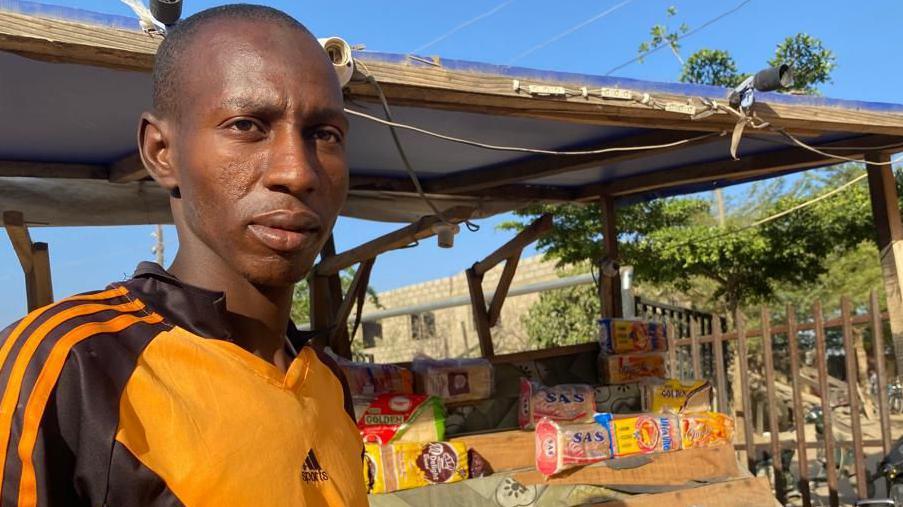 Bread-seller looking into the camera