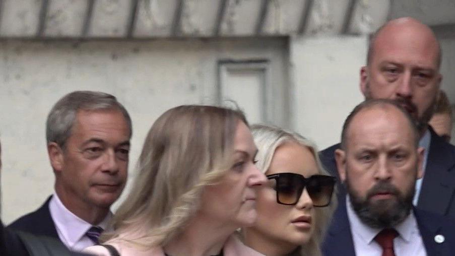 Nigel Farage (left) and Victoria Thomas Bowen (third from left) both walk towards Westminster Magistrates' Court. 