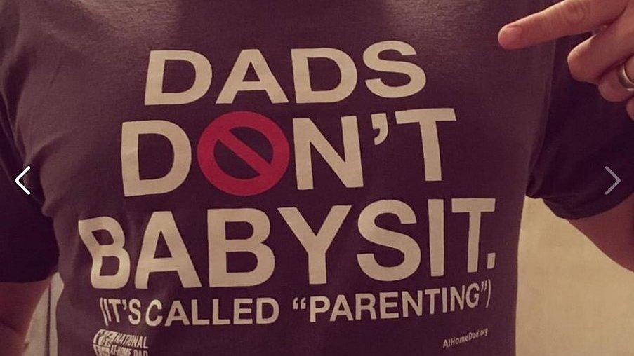 Man in t-shirt which bears a slogan: "Dads don't babysit. It's called parenting."