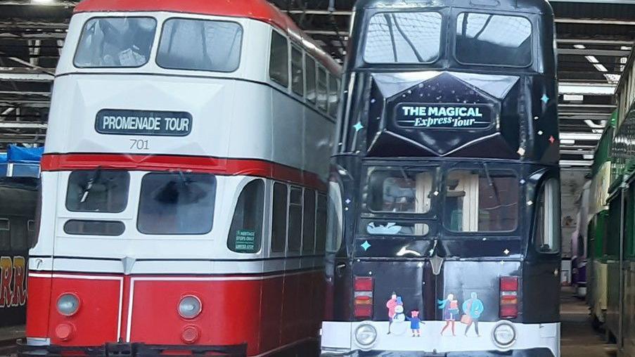 Heritage double decker trams the red and white one used for promenade tours (left) and the dark blue Magical Express tour version right