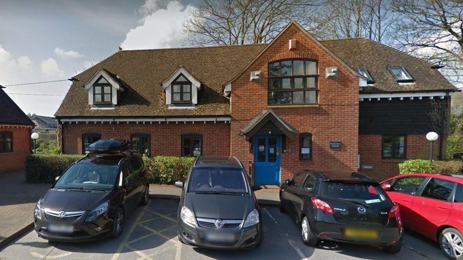 Marcella House in Hythe - red-bricked  two storey office building with cars parked outside