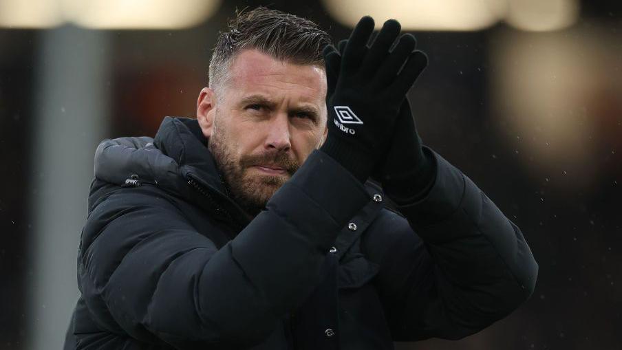 Luton Town Rob Edwards applauds supporters following their victory against Hull City