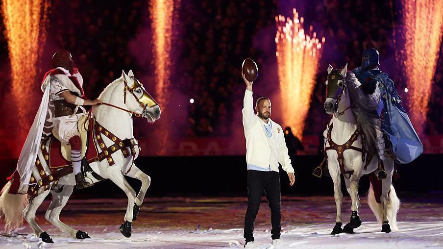 Former France player Frederic Michalak takes part in a pre-match performance with actors dressed as knights mounted on horses prior to the match between France and England