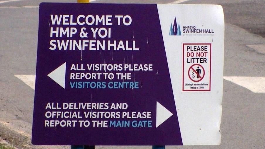An entrance sign at Swinfen Hall prison. It welcomes people to HMP and YOI Swinfen Hall. All visitors are asked to report to the visitors centre while deliveries are sent elsewhere.