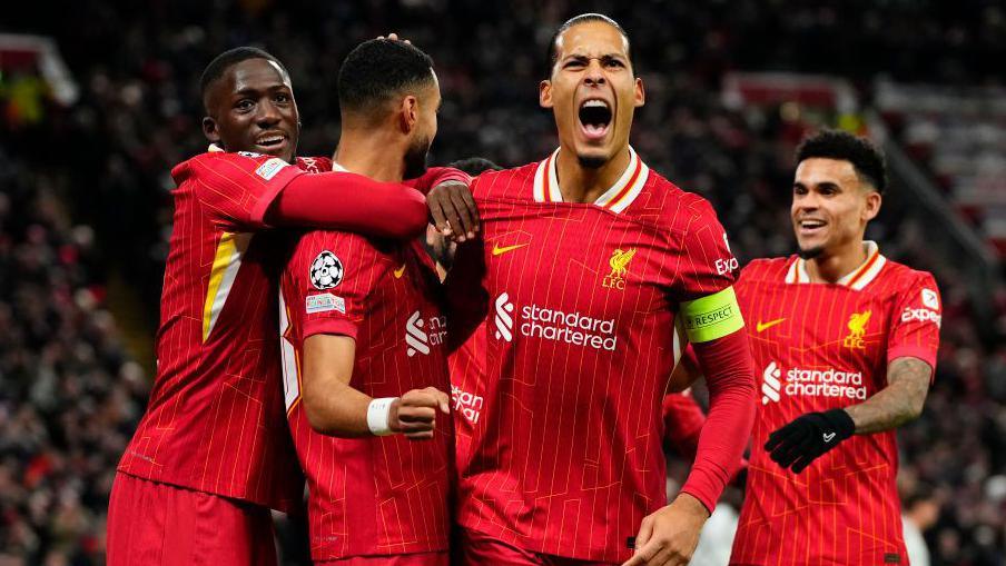 Liverpool players celebrate a win at Anfield against Manchester City