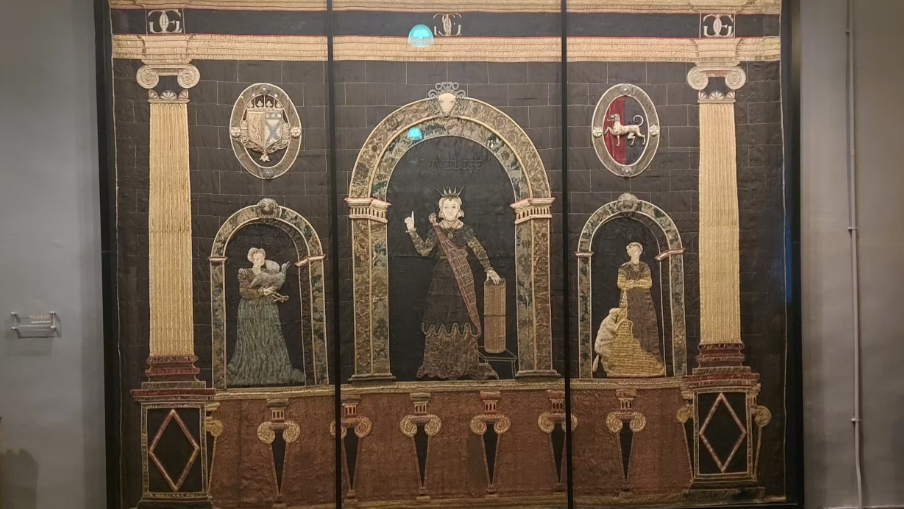 An embroidery that is from the 16th Century, including three people