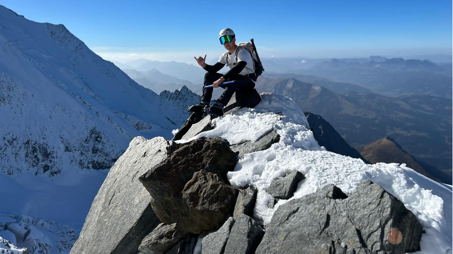 Mr Le Flem pictured on the mountain during the climb. It is a sunny day. He is wearing a helmet and goggles.