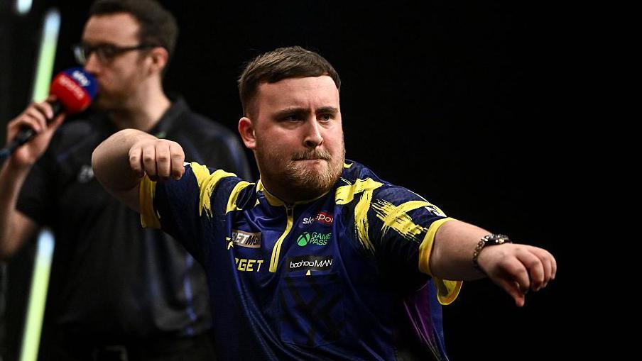 Luke Littler pictured celebrating to the crowd after hitting a 170 checkout in his Premier League Darts victory over Michael van Gerwen in Dublin
