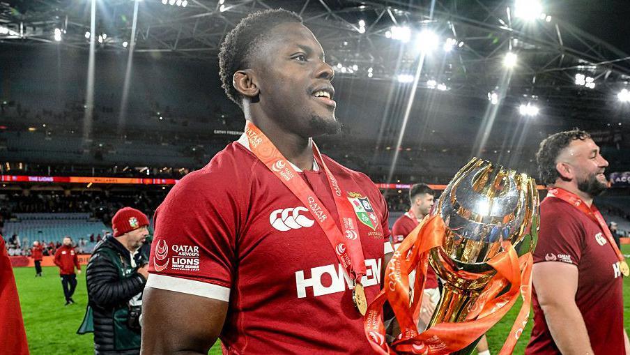 Maro Itoje holding a trophy