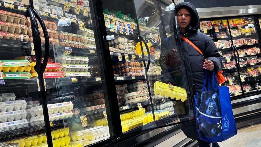  A shopper takes a carton of eggs from the cooler in a grocery store in Washington, D.C., on Saturday, April 6, 2024