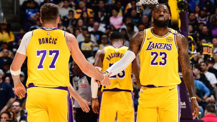 Luka Doncic (left) and LeBron James (right) shake hands on court