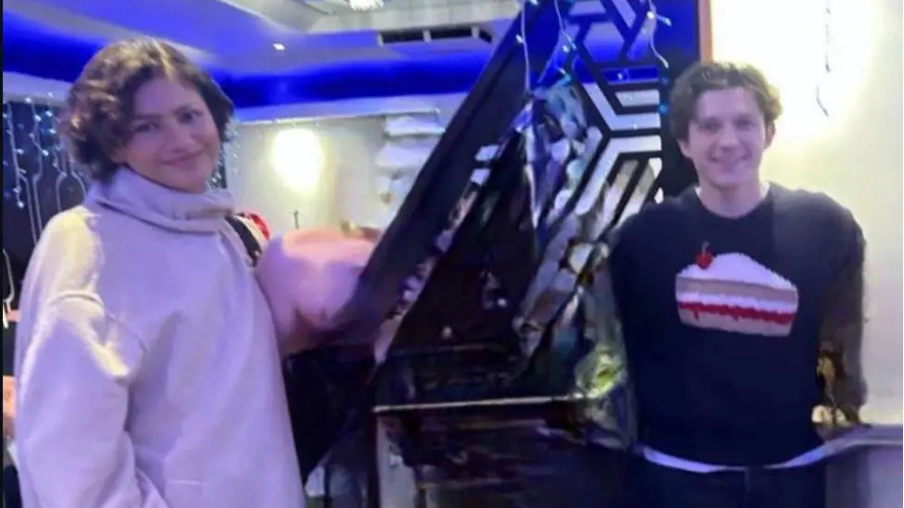 Zendaya and Tom Holland smiling at the camera