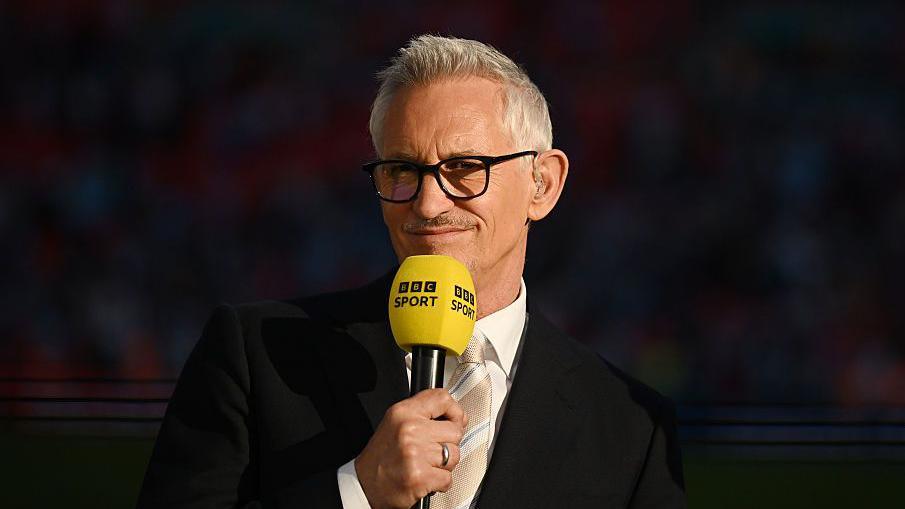 Gary Lineker holding a BBC Sport microphone