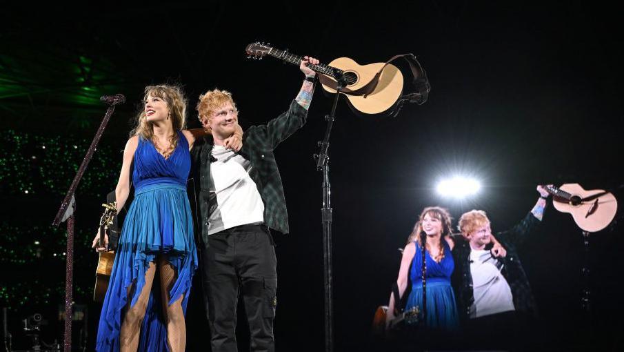 Singers Taylor Swift and Ed Sheeran hug and enjoy applause on Wembley Stadium