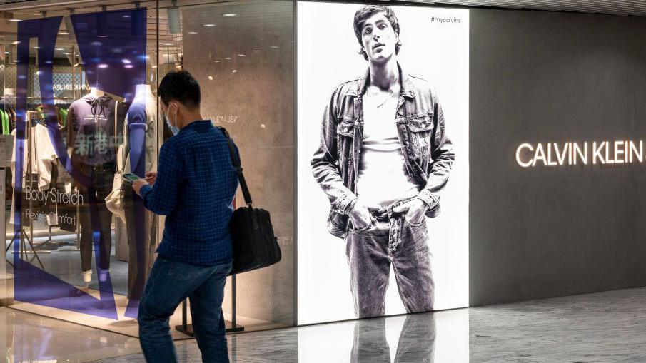 A shopper walks past the American multinational fashion brand Calvin Klein Jeans store in Hong Kong in 2021.