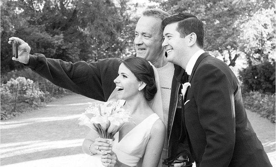 Tom Hanks takes a selfie with the couple