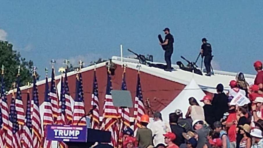 Law enforcement snipers on a roof behind the stage