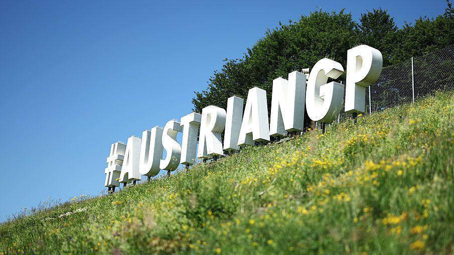 A sign at the Red Bull Ring that reads 'AustrianGP' 