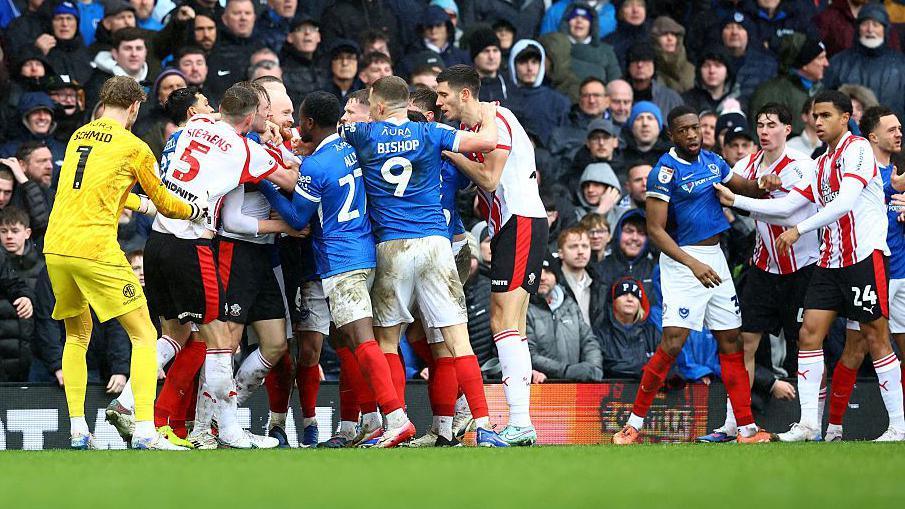 Players from Southampton and Portsmouth confront eachother after a heavy challenge in the game