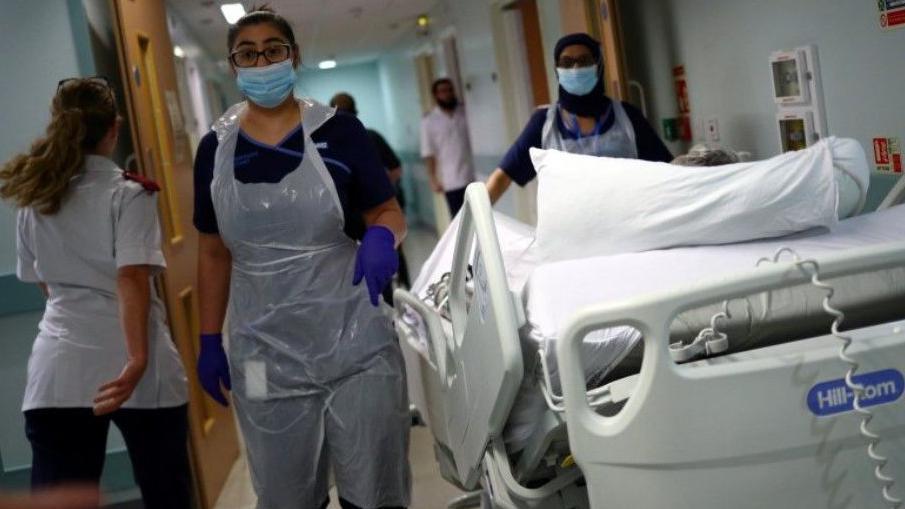 Medical staff transfer a patient through a corridor at The Royal Blackburn Teaching Hospital