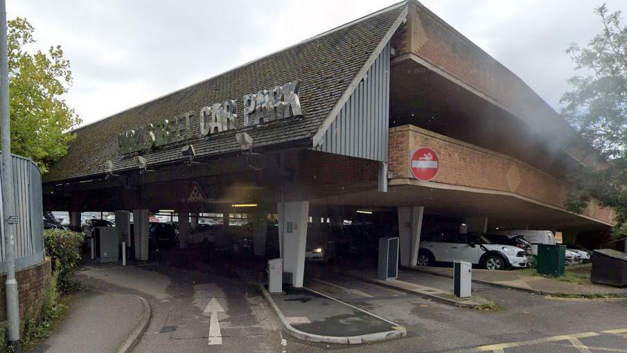 Google Maps shot of the High Street Car Park entrance. There's cars in the car park with barriers as you enter.