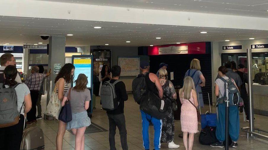 Train travellers queueing for tickets at Southampton Station