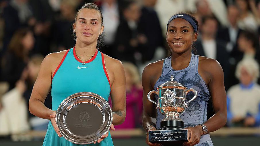 Runner-up Aryna Sabalenka and winner Coco Gauff with their trophies after the 2025 French Open