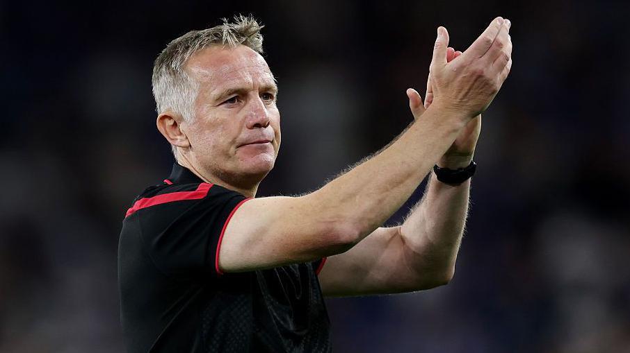 Phil Parkinson applauds at the end of the game