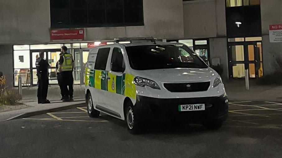 Police officers ourside the A&E department at Aberdeen Royal Infirmary at night.