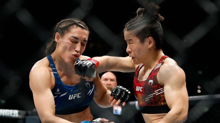 Tatiana Suarez is punched on the chin by Zhang Weili