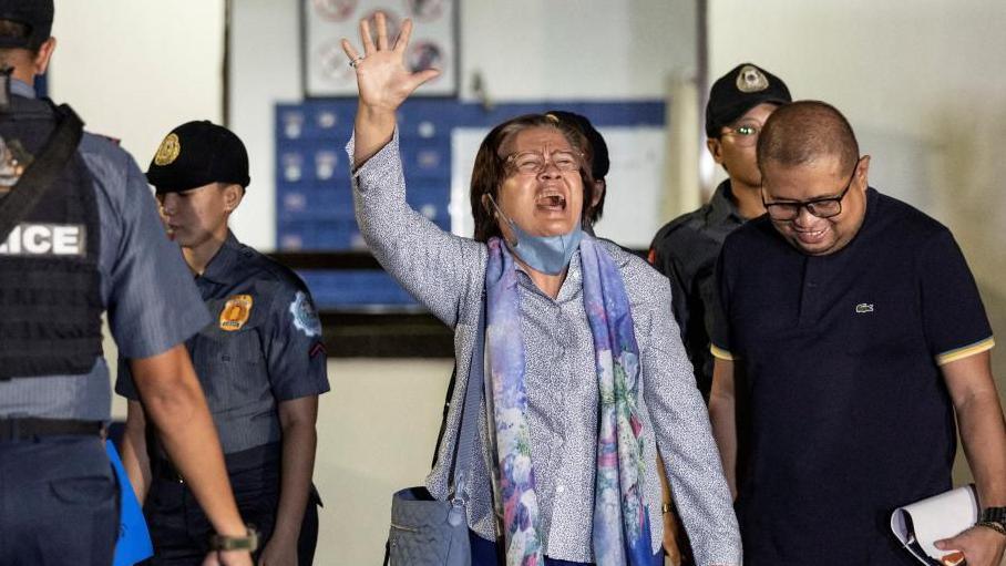  Former Philippines senator Leila de Lima waves as she walks out of the Philippine National Police custodial center after being granted bail following over six years in detention, at Quezon City, Philippines, November 13, 2023