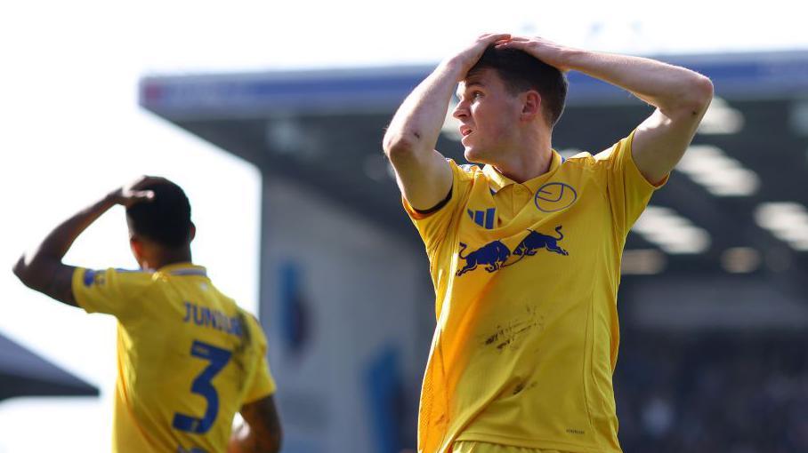 Leeds United's Sam Byram and Junior Firpo with hands on their heads after a late chance goes begging against Portsmouth.