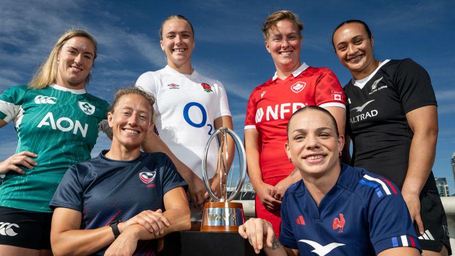 Players from the six WXV1 teams pose with the trophy in Vancouver