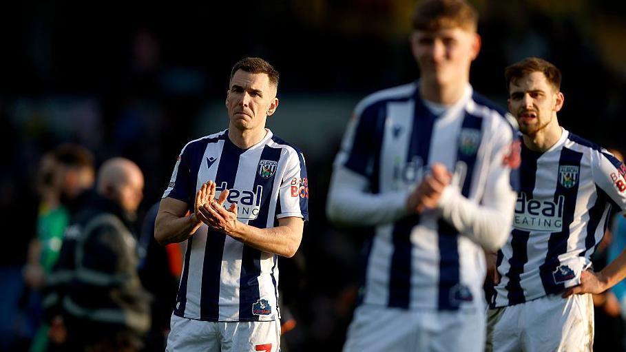 West Brom players on the pitch at full-time at the Kassam Stadium