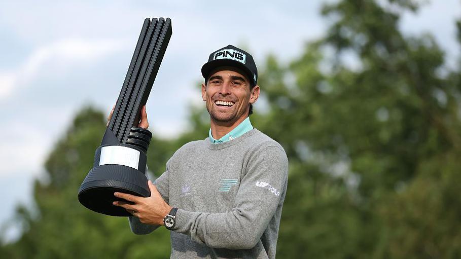 Joaquin Niemann poses with the individual trophy on day three of LIV Golf UK event