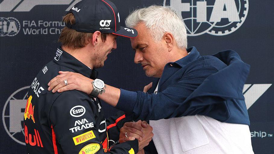 Max Verstappen is congratulated by football manager Jose Mourinho after taking pole position for the British Grand Prix