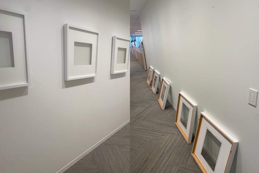 Empty frames sit on a wall and others are photographed on the ground