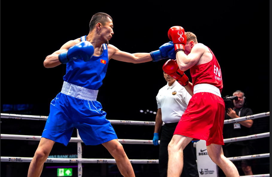 Munarbek Seiitbek Uulu, wearing all blue, throws a punch to Will Hewitt's face as he protects his face with his gloves
