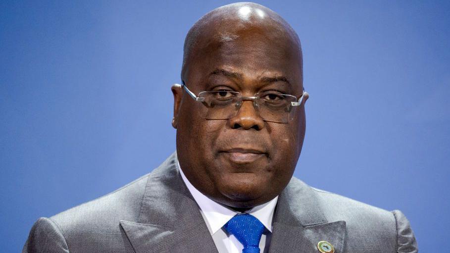 President of DR Congo Félix Tshisekedi wearing a light grey suit and a blue tie.