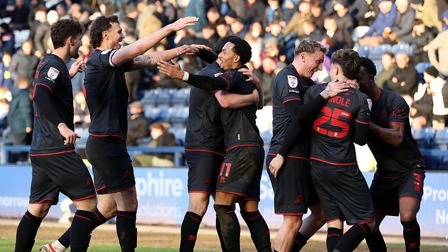 Millwall players celebrate the second goal at Deepdale in win over Preston
