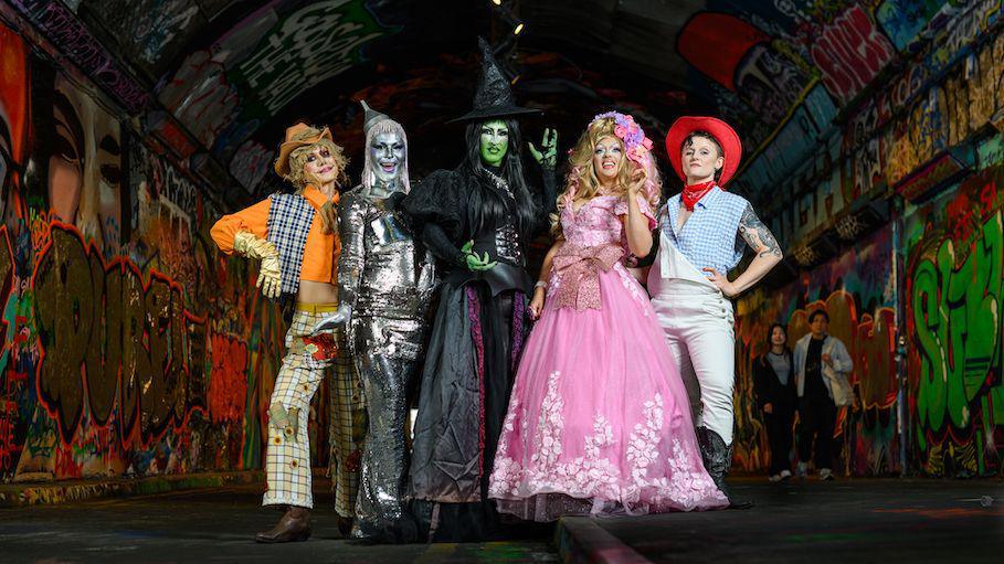 The cast posing in their costumes