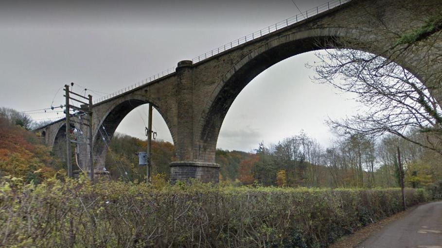 Victoria Viaduct - a large stone-built structure with several arches. Fencing runs along the top.