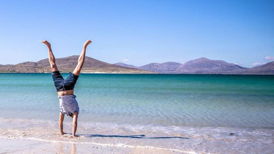 Hand stand on beach