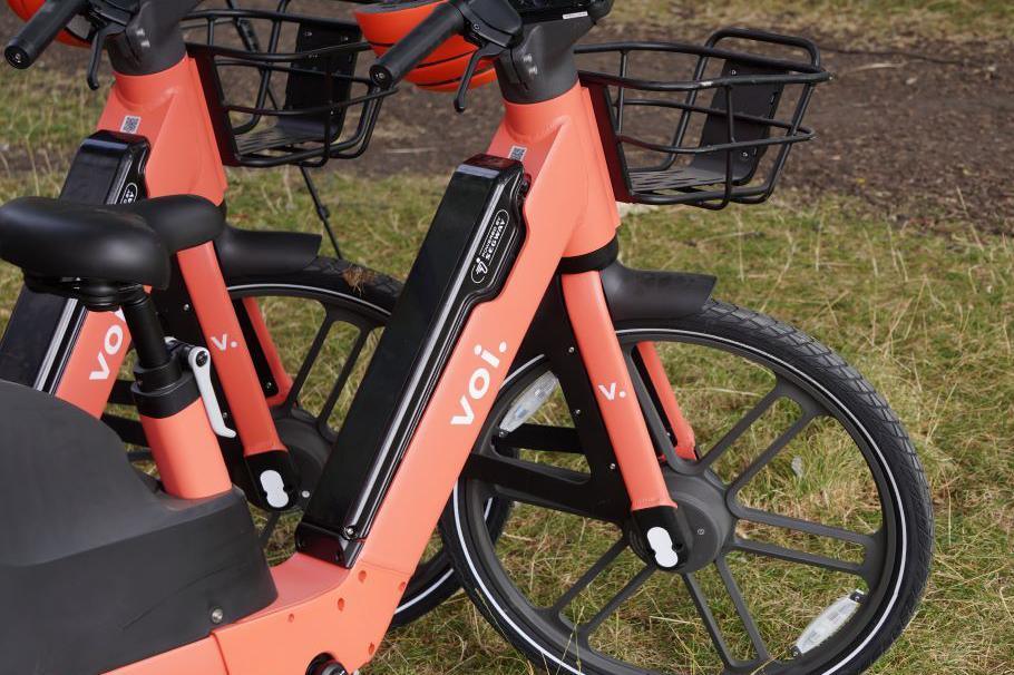 A close up of the bikes which are orange.