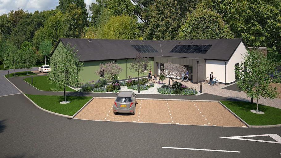 An artist's impression of a modern green and white building among leafy trees. A silver car is parked in one of four paved parking bays in front of the centre, with a tarmacked road with Give Way markings along side it.