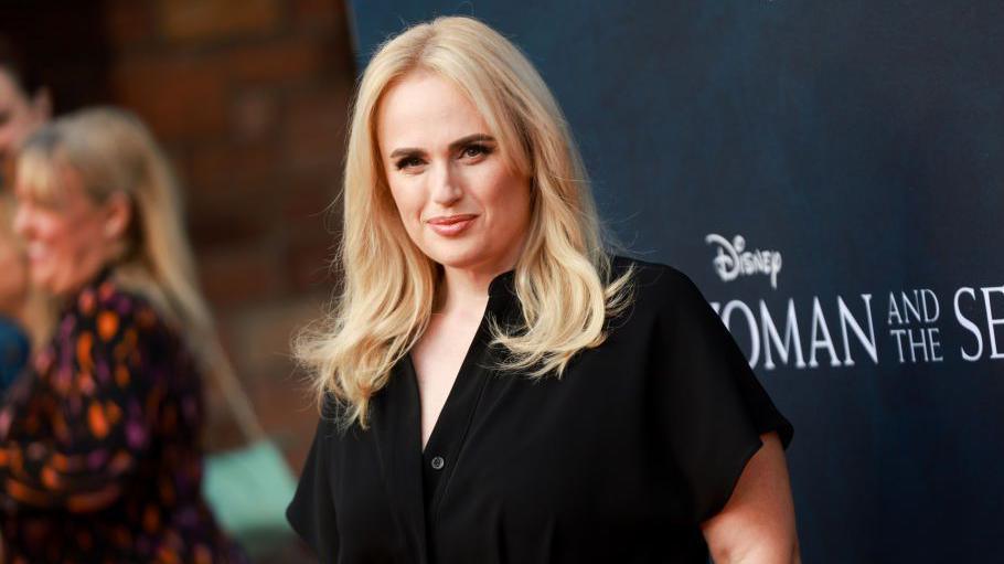 Rebel Wilson, a young woman with blonde hair wearing a black jumpsuit, attends the Walt Disney Studios premiere of "Young Woman and The Sea" at The Hollywood Roosevelt on May 16, 2024 in Los Angeles, California.