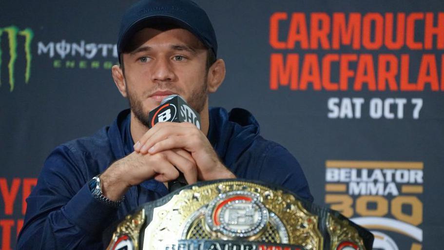 Usman Nurmagomedov speaks at a media day with his Bellator belt in front of him