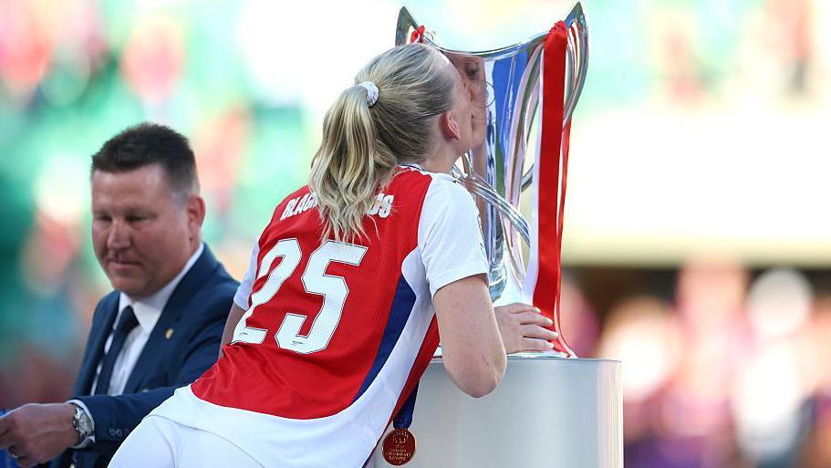 Arsenal players celebrate at the final whistle.