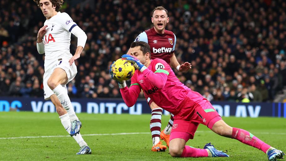 West Ham goalkeeper Lukasz Fabianski dives to save the ball in a Premier League match against Tottenham