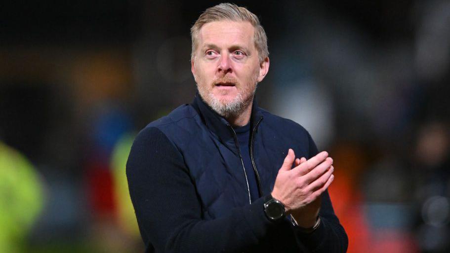 Garry Monk applauds the Cambridge United crowd after a game.